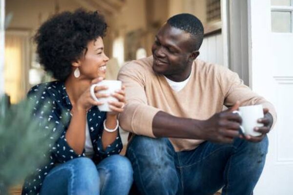 Two people talking together over cups of tea